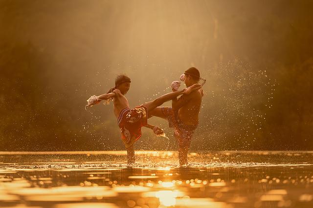 children play fighting in a river